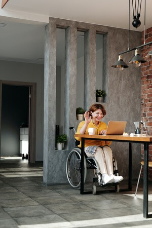 Woman on a wheelchair taking a video call