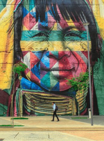 Colorful painting on a big wall of an indigenous person